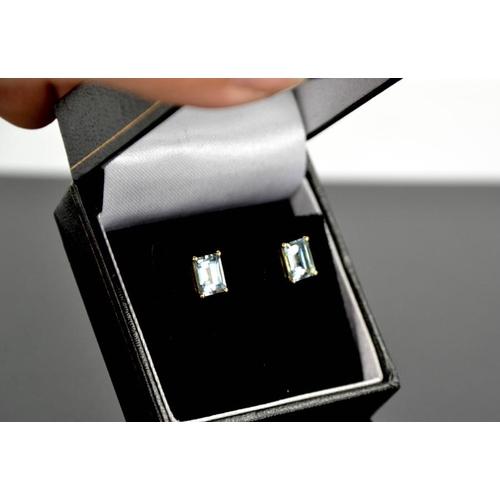 101 - A pair of 9ct yellow gold and aquamarine stud earrings, each set with cushion cut 1ct aquamarines.