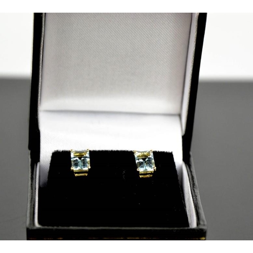 101 - A pair of 9ct yellow gold and aquamarine stud earrings, each set with cushion cut 1ct aquamarines.