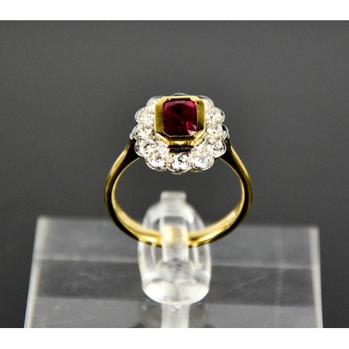 103 - An 18ct yellow gold, ruby and diamond ring, the cushion cut 1ct ruby bordered by 0.60cts, size N, 4.... 