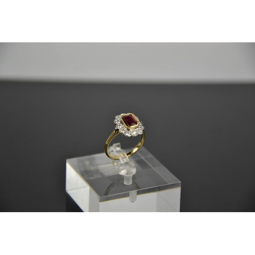 103 - An 18ct yellow gold, ruby and diamond ring, the cushion cut 1ct ruby bordered by 0.60cts, size N, 4.... 