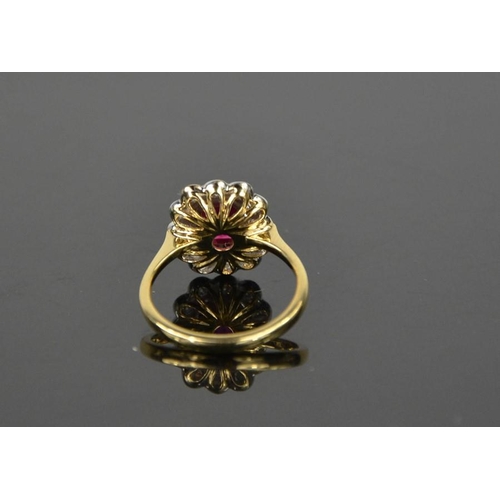 103 - An 18ct yellow gold, ruby and diamond ring, the cushion cut 1ct ruby bordered by 0.60cts, size N, 4.... 