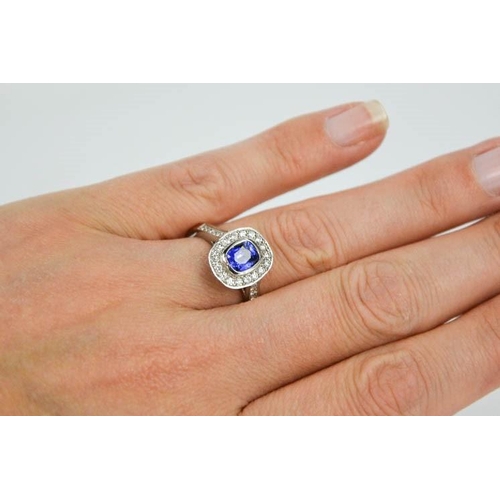 107 - An 18ct white gold sapphire and diamond ring, the sapphire approximately 0.90ct, the diamodns totall... 