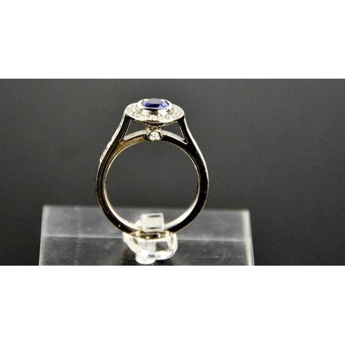 107 - An 18ct white gold sapphire and diamond ring, the sapphire approximately 0.90ct, the diamodns totall... 