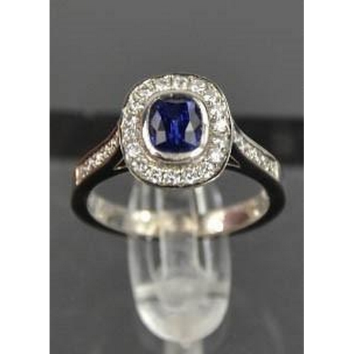 107 - An 18ct white gold sapphire and diamond ring, the sapphire approximately 0.90ct, the diamodns totall... 