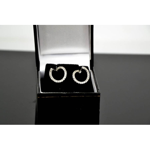 109 - A pair of 18ct white gold and diamond earrings, of contemporary design, the diamonds totalling 0.46c... 
