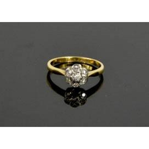 110 - An 18ct yellow gold, platinum and diamond daisy ring, size M½, 2.6g.
