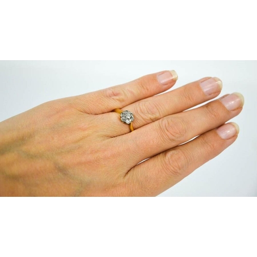 110 - An 18ct yellow gold, platinum and diamond daisy ring, size M½, 2.6g.