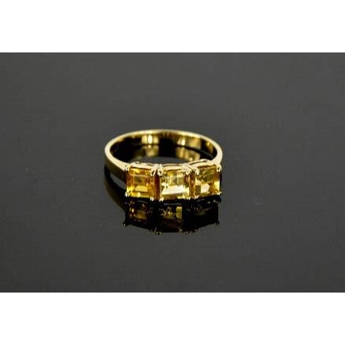 112 - A 9ct yellow gold and citrine ring, set with three square cut citrines, size R, 3.1g.