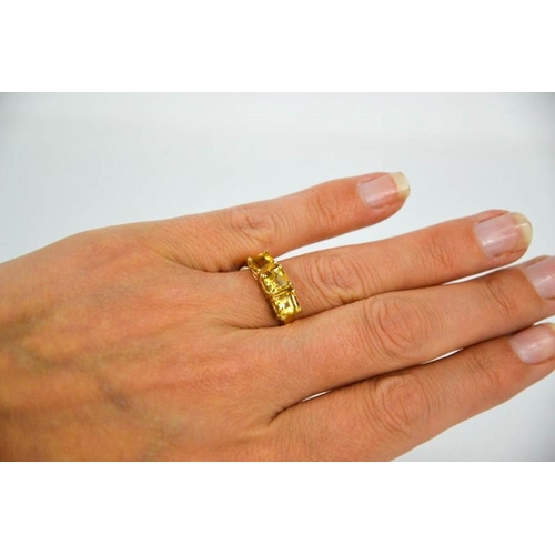 112 - A 9ct yellow gold and citrine ring, set with three square cut citrines, size R, 3.1g.