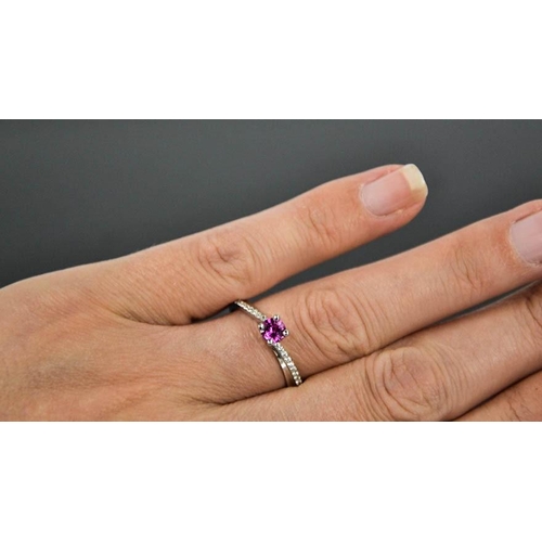 58 - A 14ct white gold, pink sapphire and diamond ring, the sapphire approximately 0.5cts, size O½, 3.4g.
