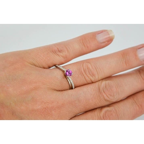 58 - A 14ct white gold, pink sapphire and diamond ring, the sapphire approximately 0.5cts, size O½, 3.4g.