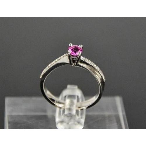 58 - A 14ct white gold, pink sapphire and diamond ring, the sapphire approximately 0.5cts, size O½, 3.4g.