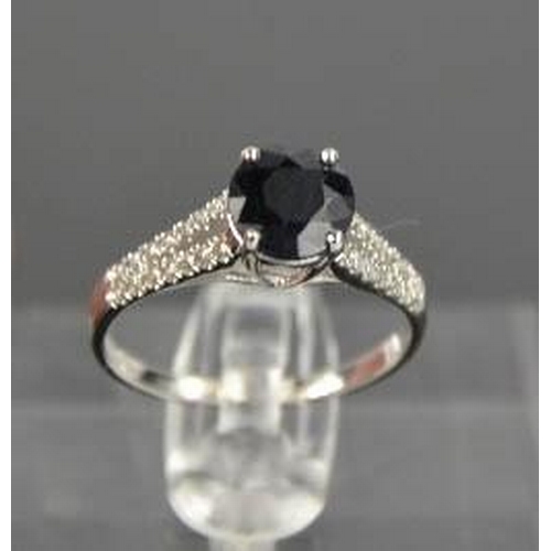 63 - A 14ct white gold, black sapphire and diamond ring, size M, 2.3g.
