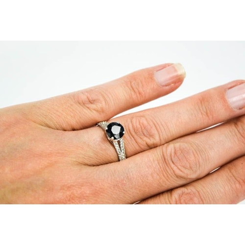 63 - A 14ct white gold, black sapphire and diamond ring, size M, 2.3g.