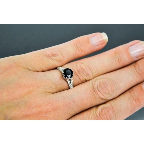63 - A 14ct white gold, black sapphire and diamond ring, size M, 2.3g.