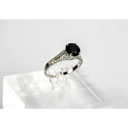 63 - A 14ct white gold, black sapphire and diamond ring, size M, 2.3g.