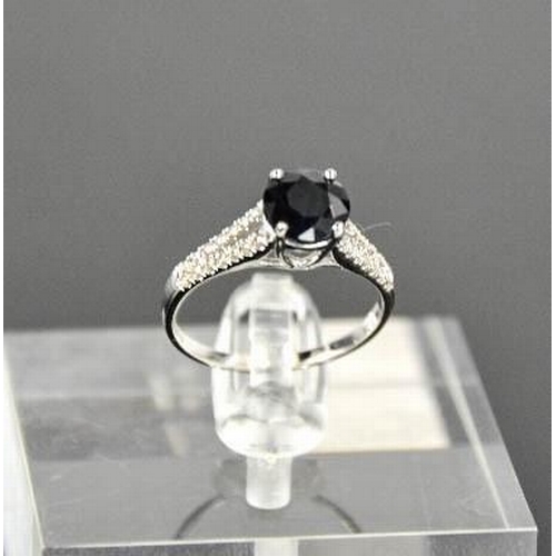 63 - A 14ct white gold, black sapphire and diamond ring, size M, 2.3g.