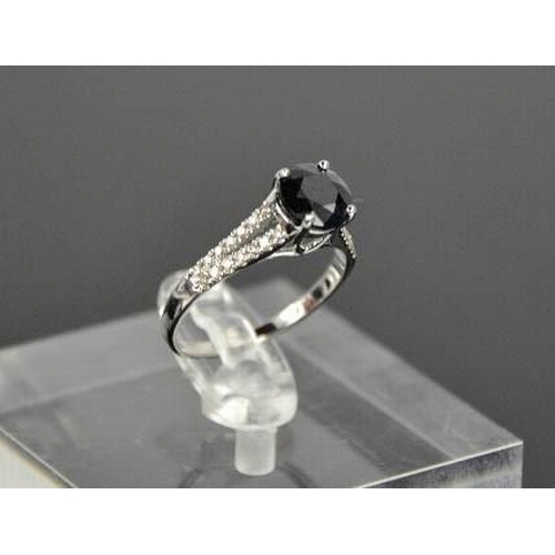 63 - A 14ct white gold, black sapphire and diamond ring, size M, 2.3g.