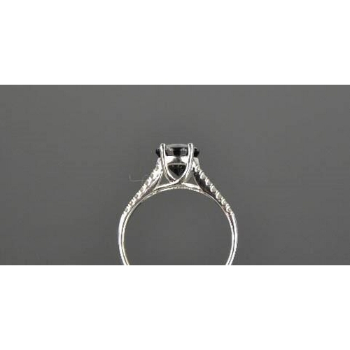63 - A 14ct white gold, black sapphire and diamond ring, size M, 2.3g.