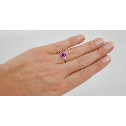65 - An 18ct white gold, pink sapphire and diamond ring, the sapphire approximately 1ct, the diamonds 0.2... 