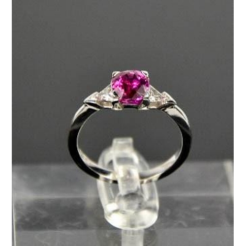 65 - An 18ct white gold, pink sapphire and diamond ring, the sapphire approximately 1ct, the diamonds 0.2... 