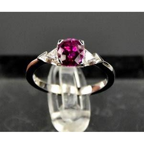 65 - An 18ct white gold, pink sapphire and diamond ring, the sapphire approximately 1ct, the diamonds 0.2... 