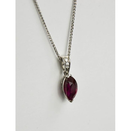 67 - An 18ct white gold, ruby and diamond pendant and chain, the ruby 2ct, the diamonds set to the hoop, ... 