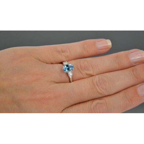 69 - An 18ct white gold, aquamarine and diamond ring, the 1.20ct aquamarine flanked by 0.20cts diamonds i... 