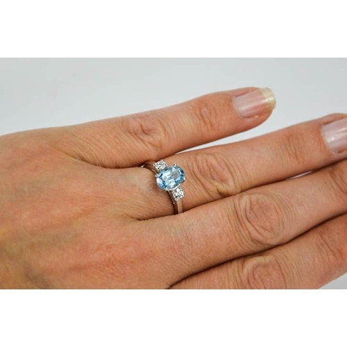 69 - An 18ct white gold, aquamarine and diamond ring, the 1.20ct aquamarine flanked by 0.20cts diamonds i... 