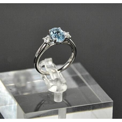 69 - An 18ct white gold, aquamarine and diamond ring, the 1.20ct aquamarine flanked by 0.20cts diamonds i... 