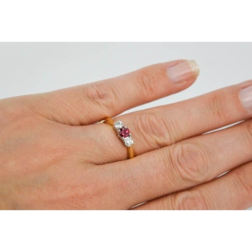 73 - An 18ct yellow gold, diamond and garnet trilogy ring, the central garnet flanked by diamonds, size M... 