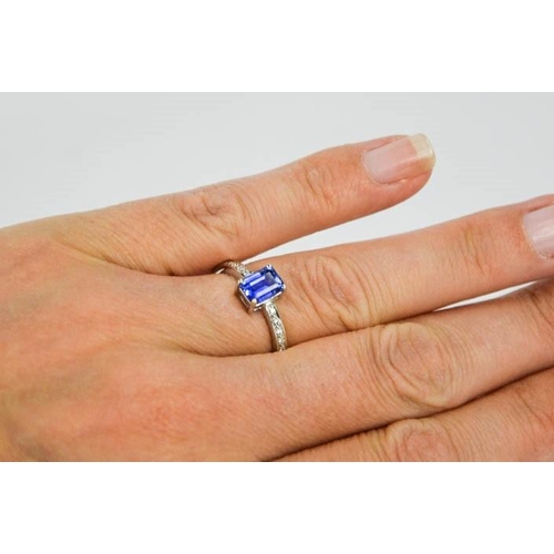 75 - An 18ct white gold, diamond and sapphire ring, the sapphire approximately 0.80ct, with diamond set s... 