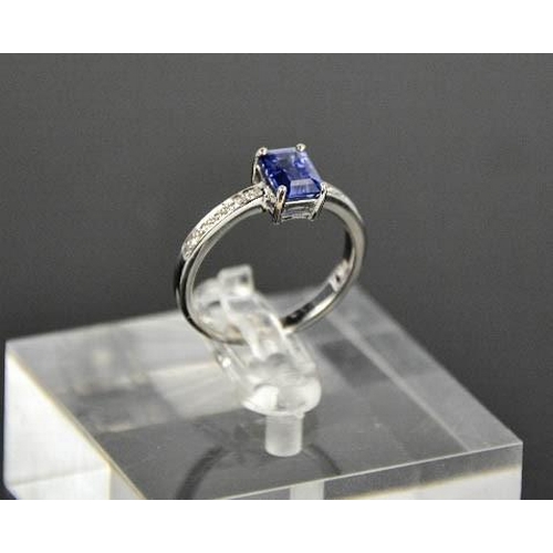 75 - An 18ct white gold, diamond and sapphire ring, the sapphire approximately 0.80ct, with diamond set s... 