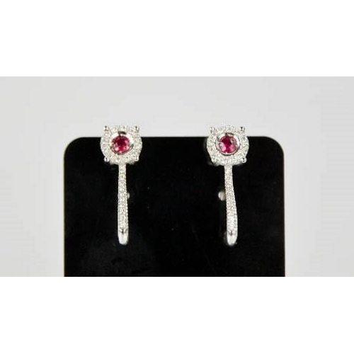 79 - An 18ct white gold, ruby and diamond earrings, the rubies totalling approximately 0.3ct, the diamond... 