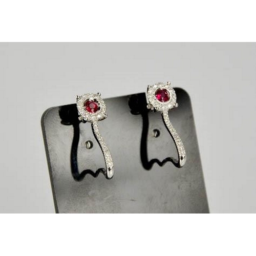 79 - An 18ct white gold, ruby and diamond earrings, the rubies totalling approximately 0.3ct, the diamond... 