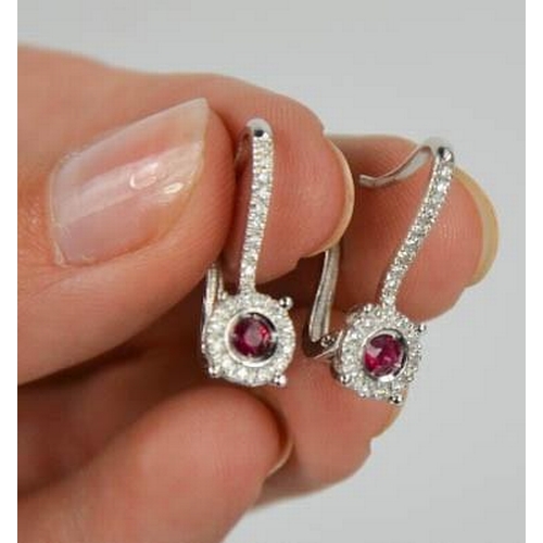 79 - An 18ct white gold, ruby and diamond earrings, the rubies totalling approximately 0.3ct, the diamond... 
