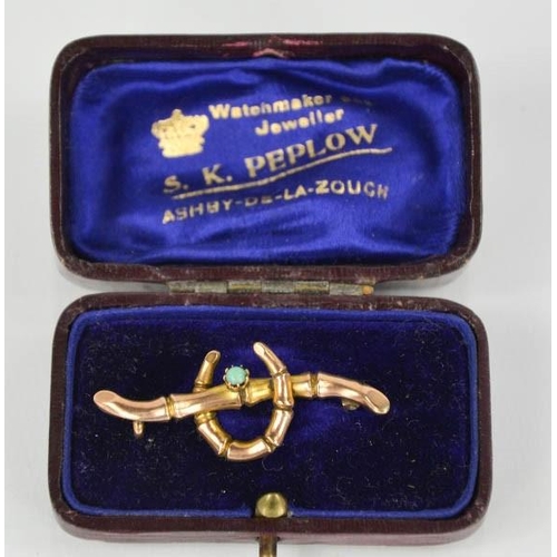 81 - A 9ct gold sweetheart brooch, in the form of a horseshoe with turquoise  1.8g.