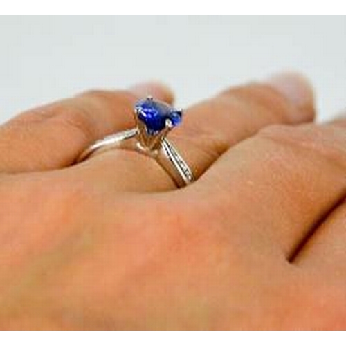 84 - An 18ct white gold, blue sapphire and diamond ring, the sapphire approximately 0.7g, the diamonds to... 