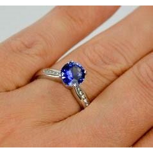 84 - An 18ct white gold, blue sapphire and diamond ring, the sapphire approximately 0.7g, the diamonds to... 