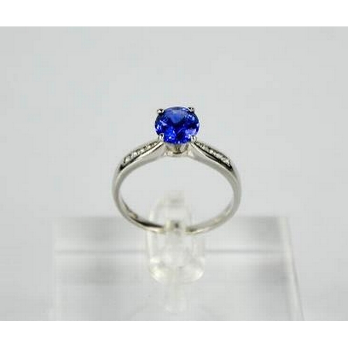 84 - An 18ct white gold, blue sapphire and diamond ring, the sapphire approximately 0.7g, the diamonds to... 