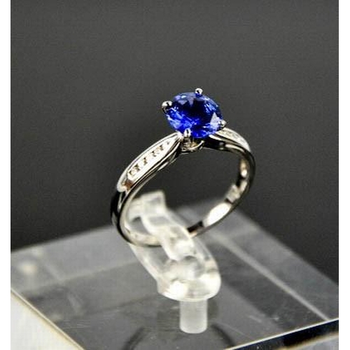84 - An 18ct white gold, blue sapphire and diamond ring, the sapphire approximately 0.7g, the diamonds to... 