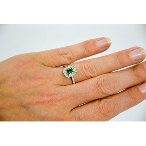 87 - An 18ct white gold, emerald and diamond ring, size N½, 3.7g.