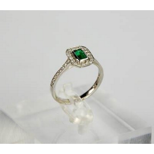 87 - An 18ct white gold, emerald and diamond ring, size N½, 3.7g.