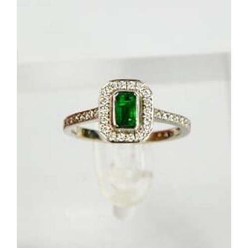 87 - An 18ct white gold, emerald and diamond ring, size N½, 3.7g.