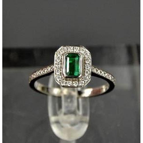 87 - An 18ct white gold, emerald and diamond ring, size N½, 3.7g.