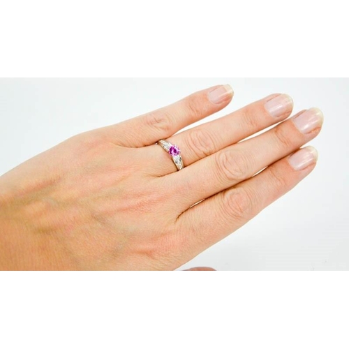 90 - A 14ct white gold, pink sapphire, and diamond ring, the sapphire approximately 0.5ct, the diamonds t... 