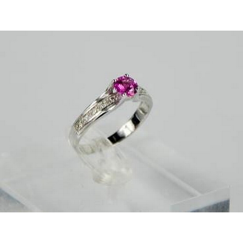 90 - A 14ct white gold, pink sapphire, and diamond ring, the sapphire approximately 0.5ct, the diamonds t... 
