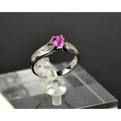 90 - A 14ct white gold, pink sapphire, and diamond ring, the sapphire approximately 0.5ct, the diamonds t... 
