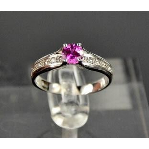 90 - A 14ct white gold, pink sapphire, and diamond ring, the sapphire approximately 0.5ct, the diamonds t... 