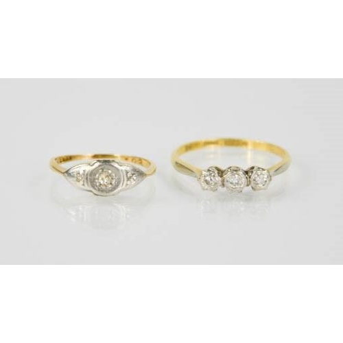 91 - An 18ct gold, platinum and diamond three stone ring, size I/J, and an 18ct gold ring set with three ... 
